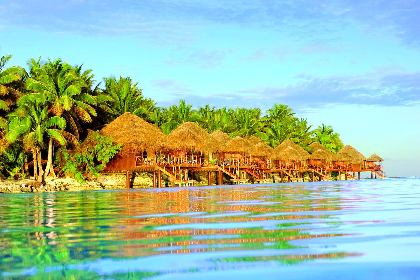 Overwater bungalows at Aitutaki Lagoon Private Island Resort