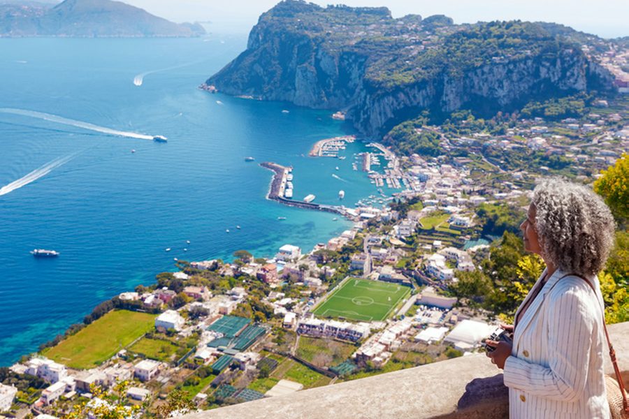 A traveller overlooking the Mediterranean coast of Capri