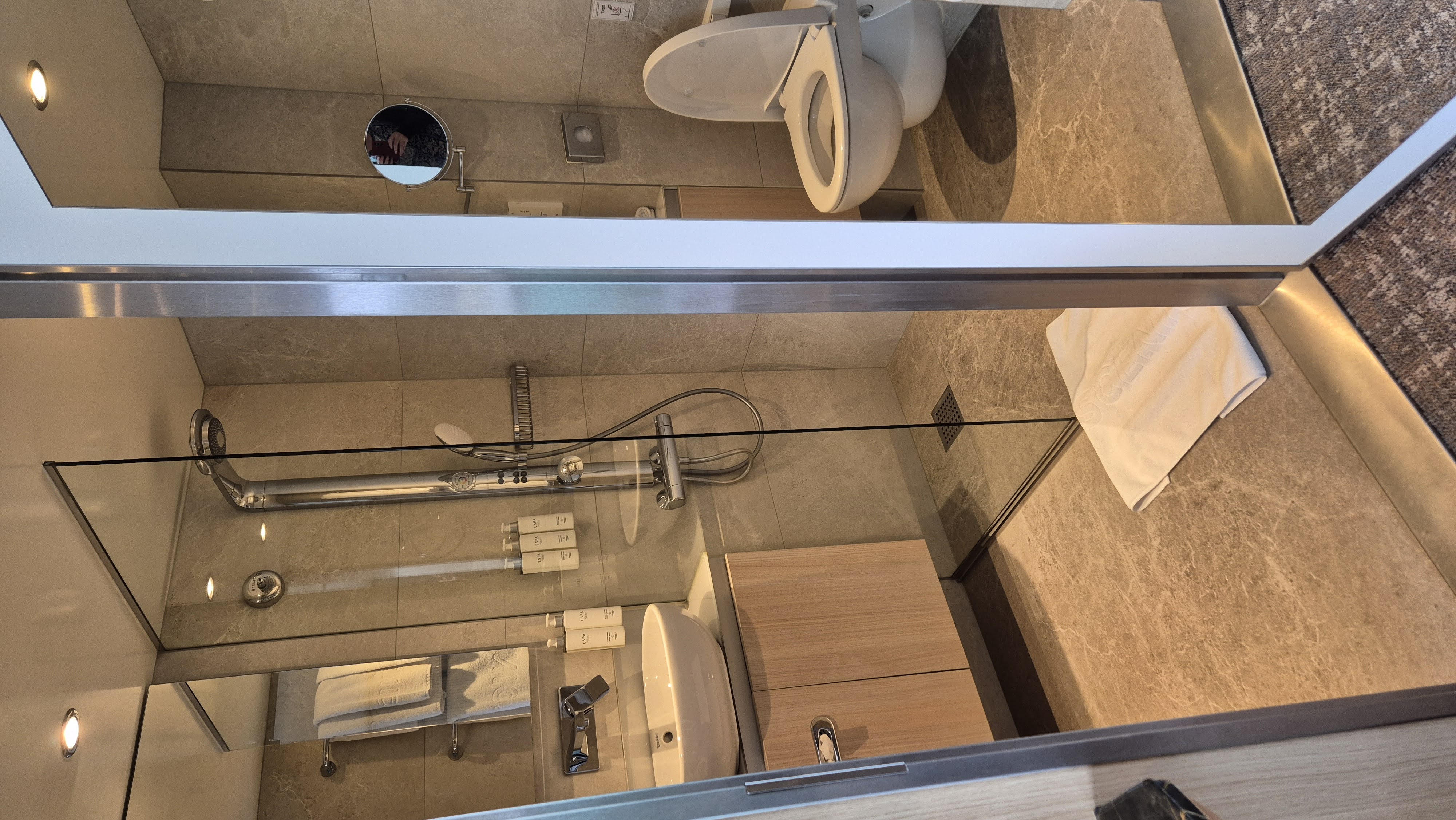 The bathroom of a Scenic Crystal Balcony Suite, with a large walk-in shower