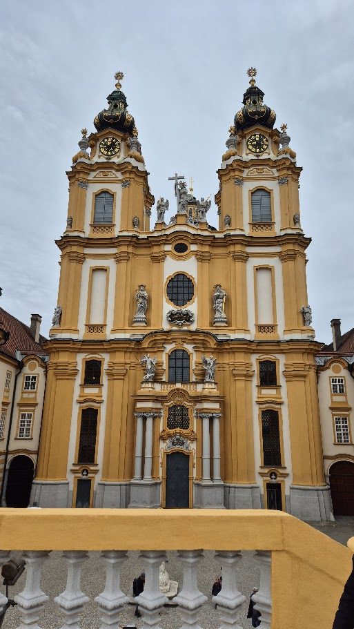 The ochre Baroque façade and twin towers of Melk Abbey