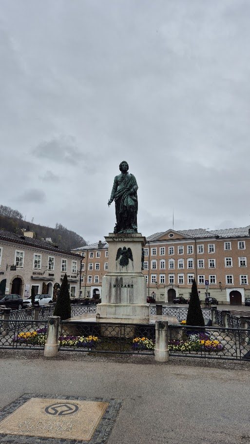 The Mozart statue in Salzburg's Mozartplatz on a grey, wet day