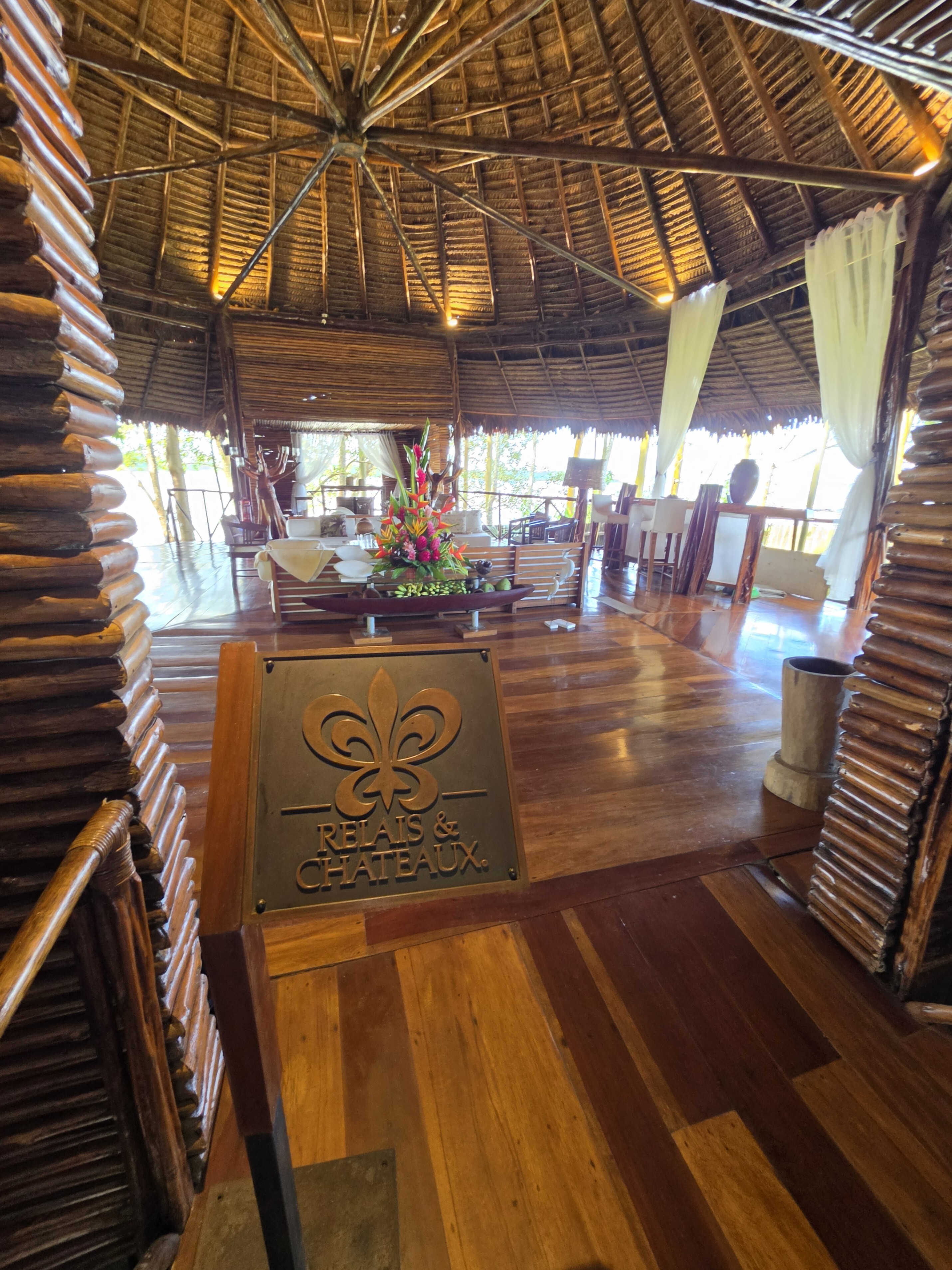 The thatched Delfin lodge, with a Relais & Châteaux plaque at the entrance